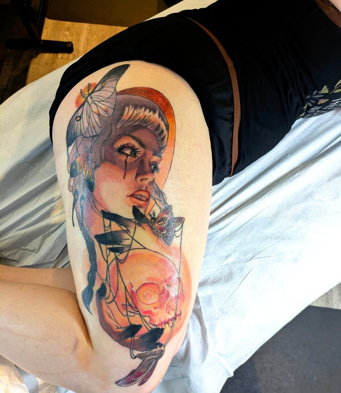 Woman with skull watercolor tattoo on the thigh by Lahel (Lay-el) Fowler