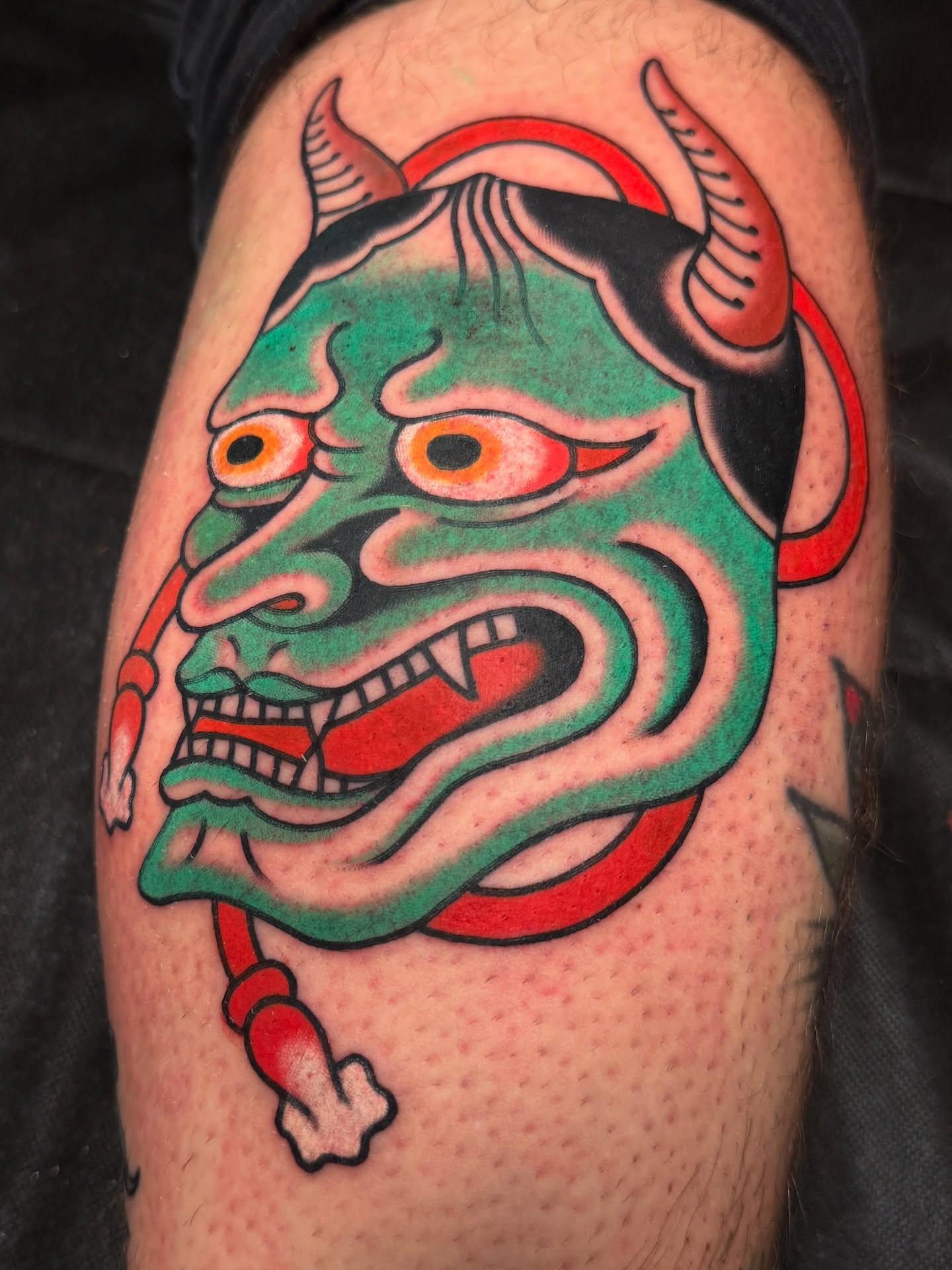 Demon mask American traditional tattoo on the thigh by Chaz Otto