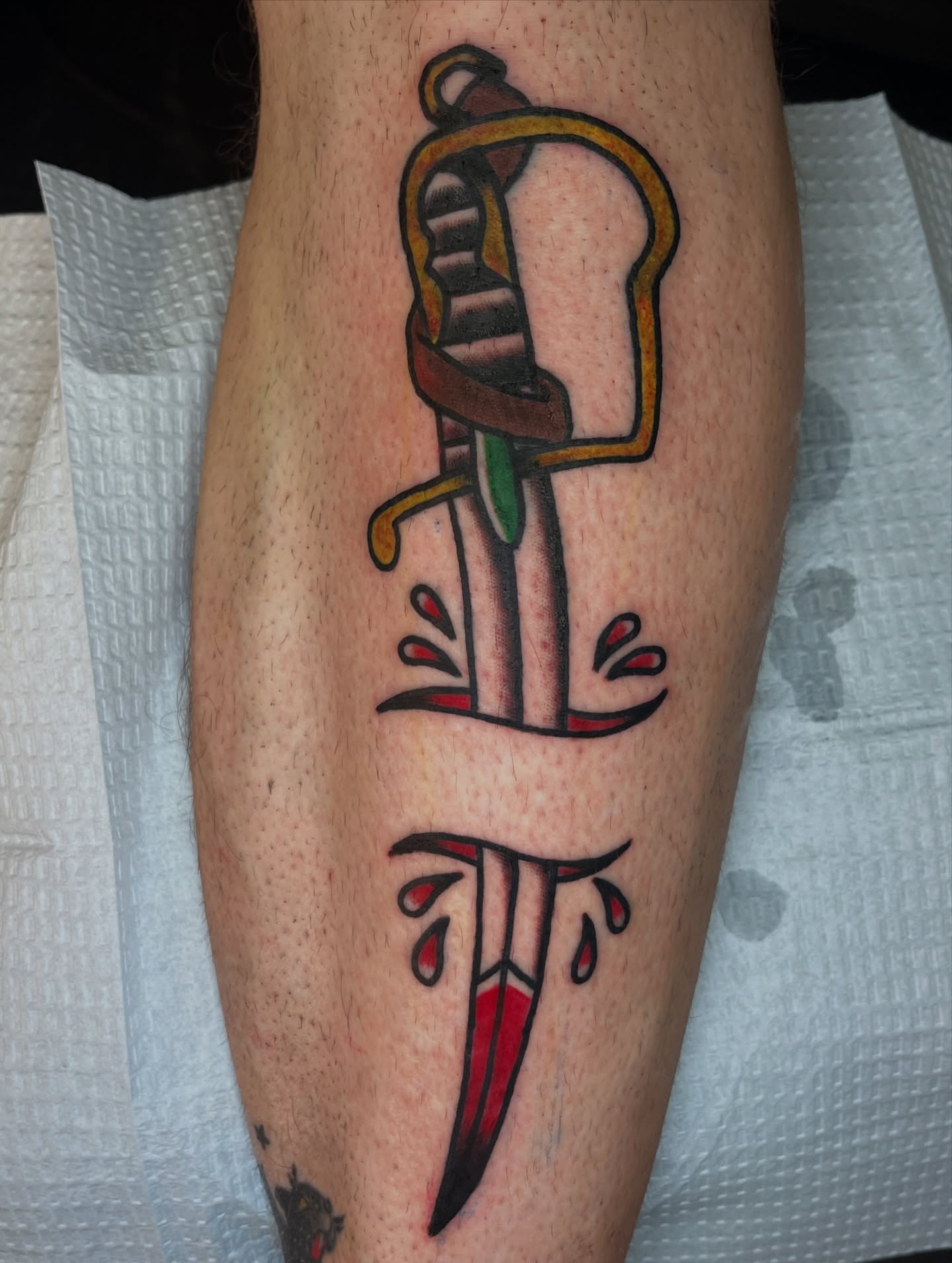 Sword and blood American traditional tattoo on the leg by Ryan Kim