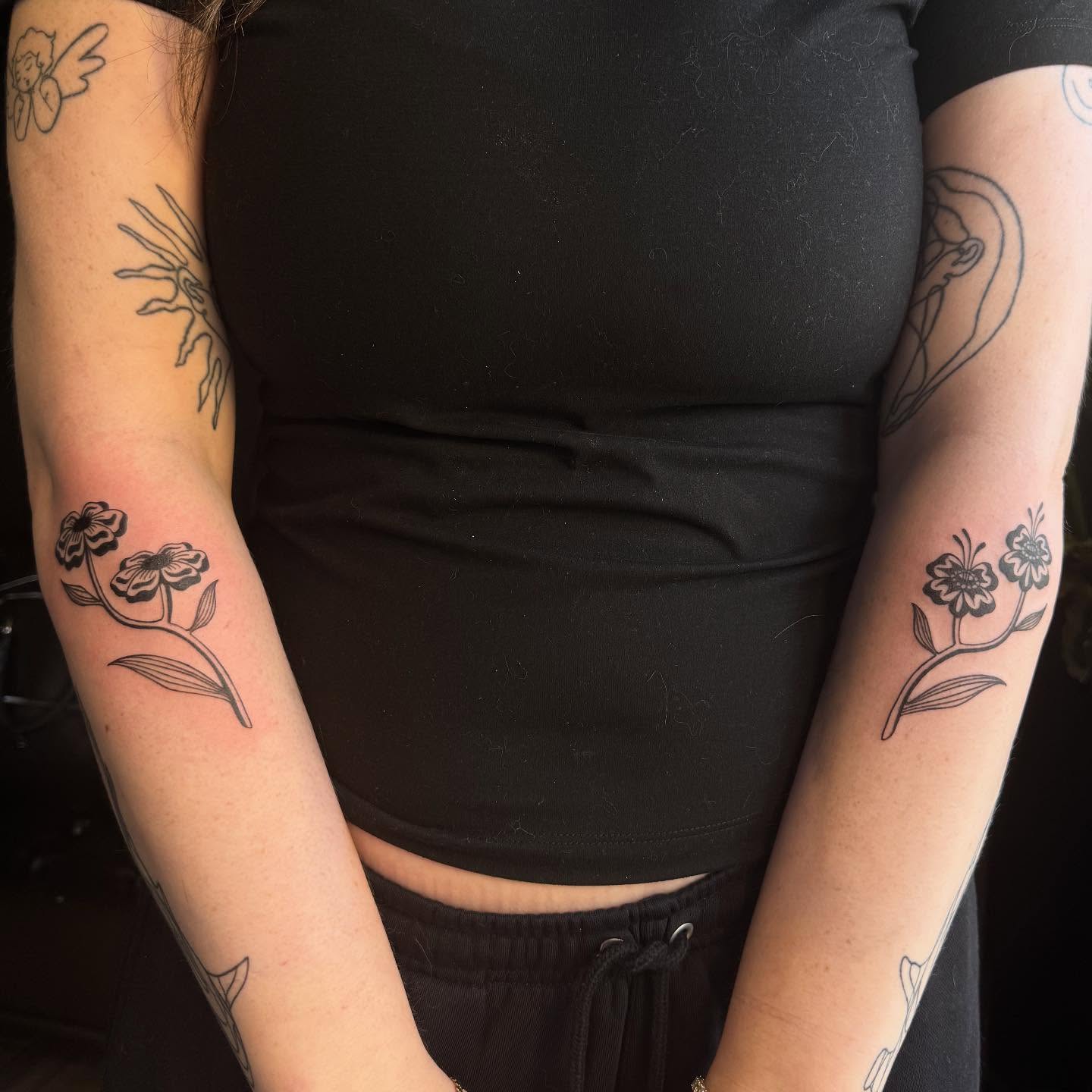 Flowers black and grey tattoo on the forearm by Mickey