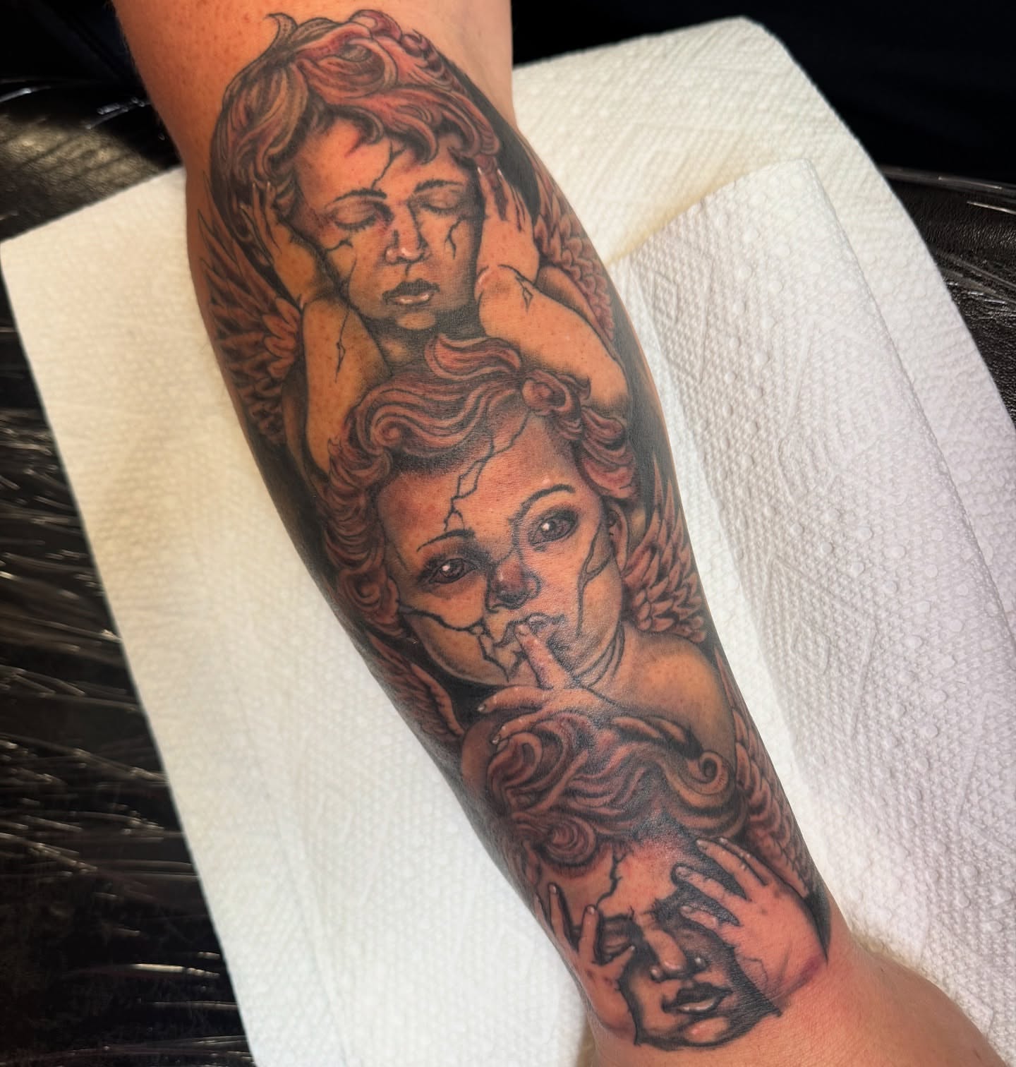 Angels realism tattoo on the forearm by Erin Moore