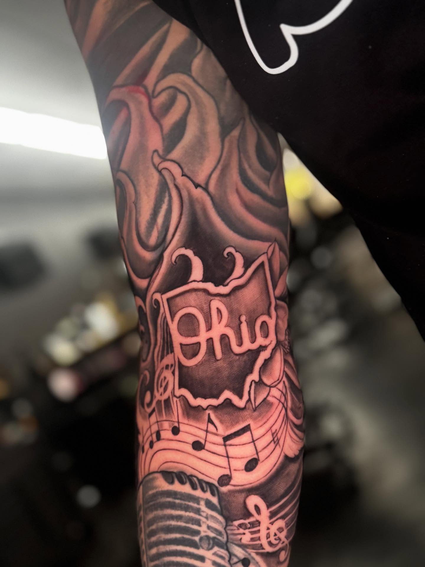 Music-themed design realism tattoo on the forearm by Shawn Skale