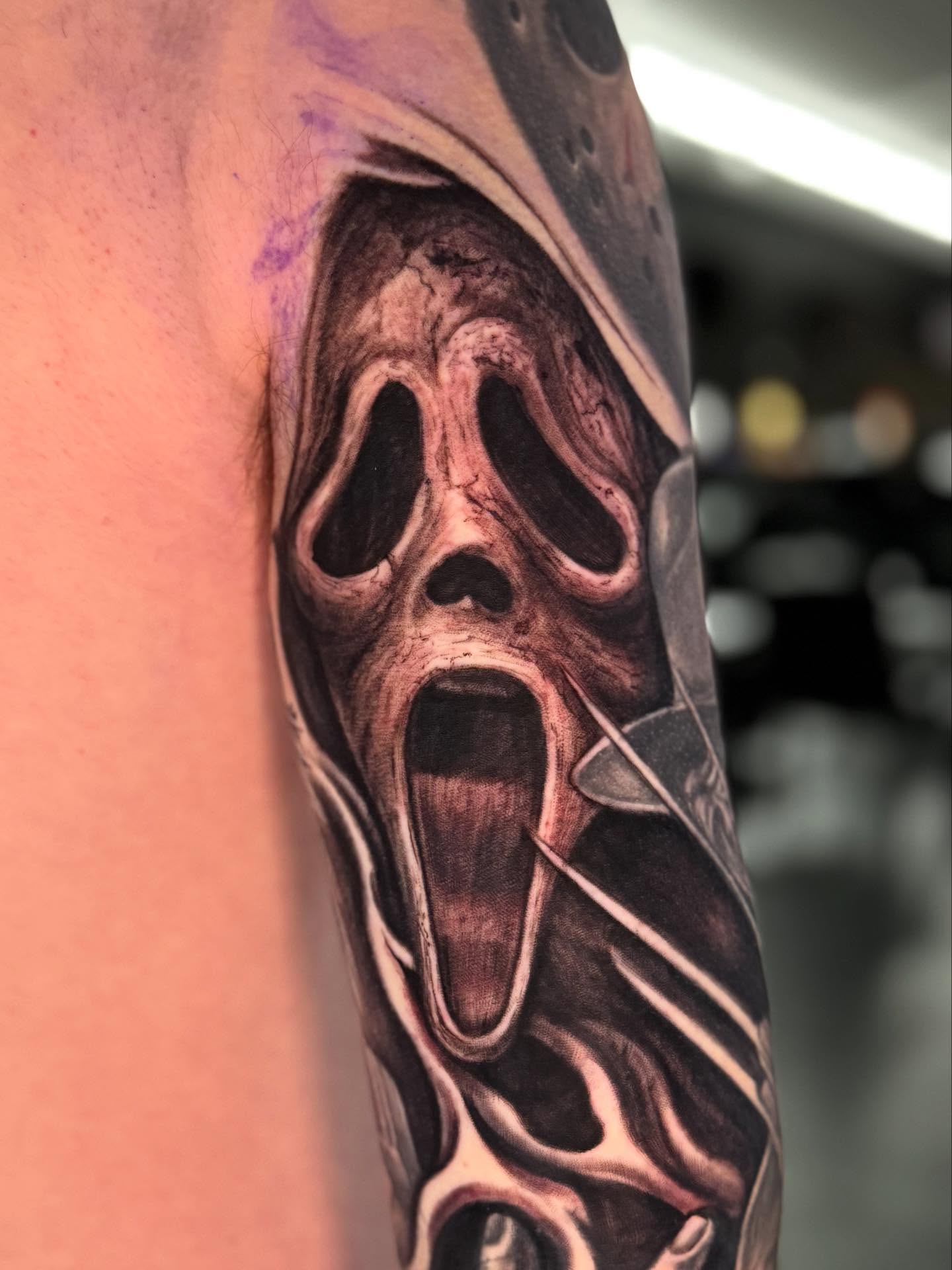 Scream mask realism tattoo on the forearm by Shawn Skale