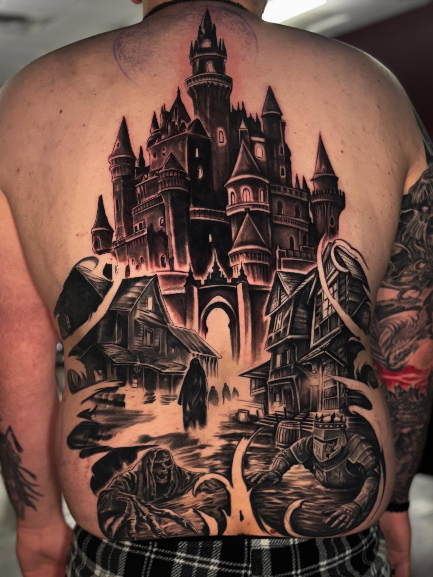 Castle and town realism tattoo on the back by Shawn Skale