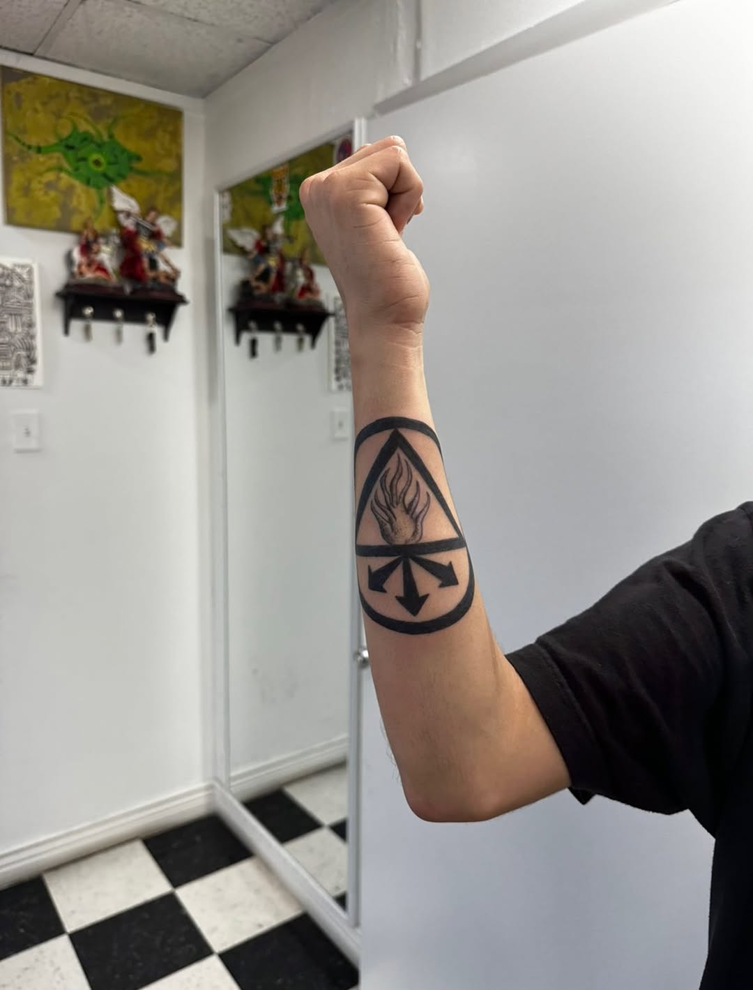 Symbol with flame and arrows tattoo on the forearm by Lupita Ink