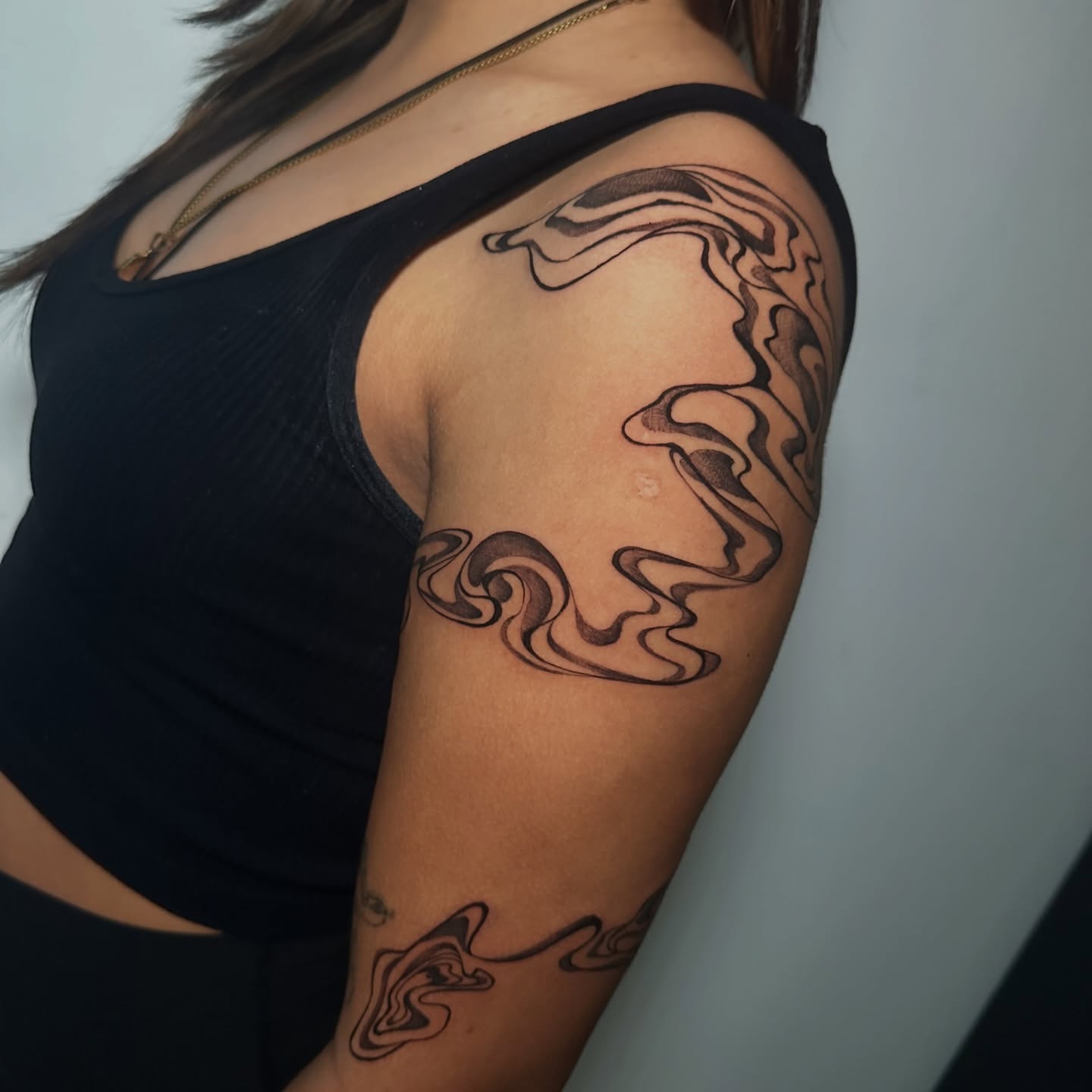 Swirls black and grey tattoo on the upper arm by Crystal, Las Vegas, Nevada
