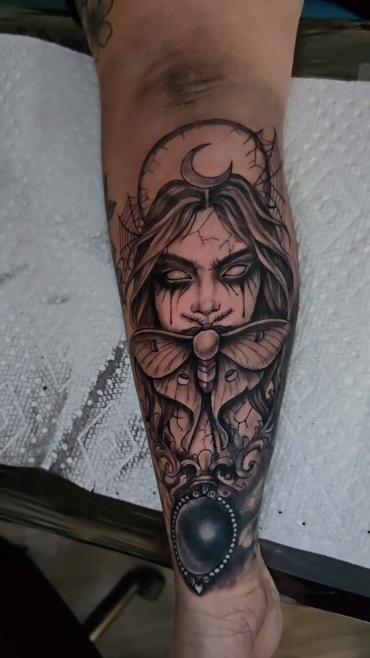 Woman with moth and gem dark realism tattoo by Jesse James, Las Vegas, Nevada