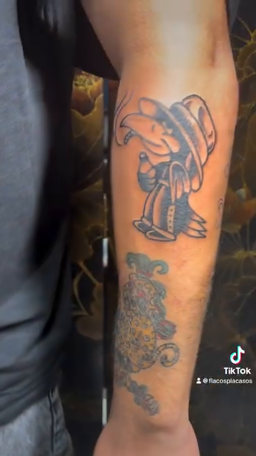 Cartoon character with hat realism tattoo by Eli Flores