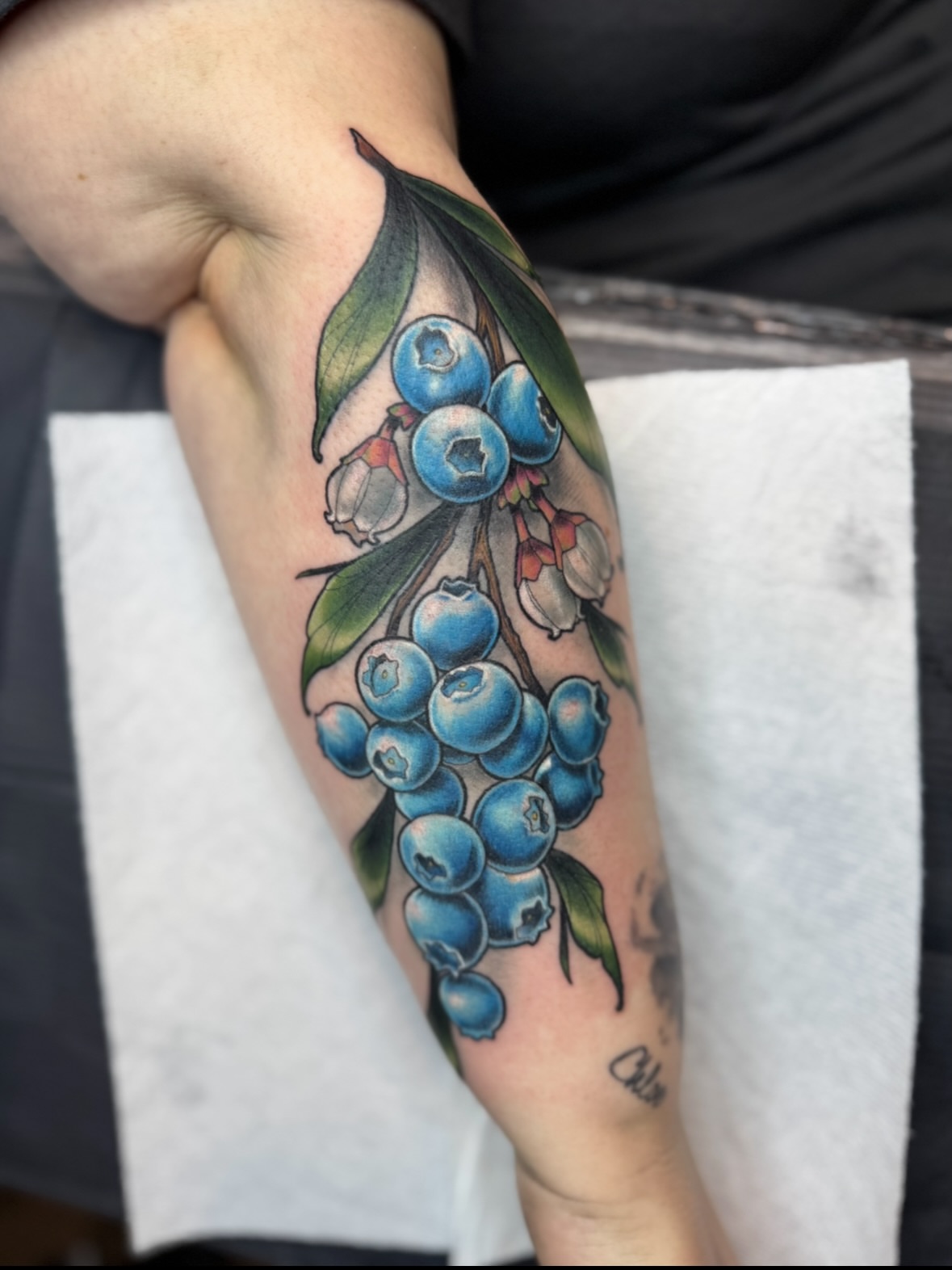 Blueberries realism tattoo on the forearm by Erin Bratzler