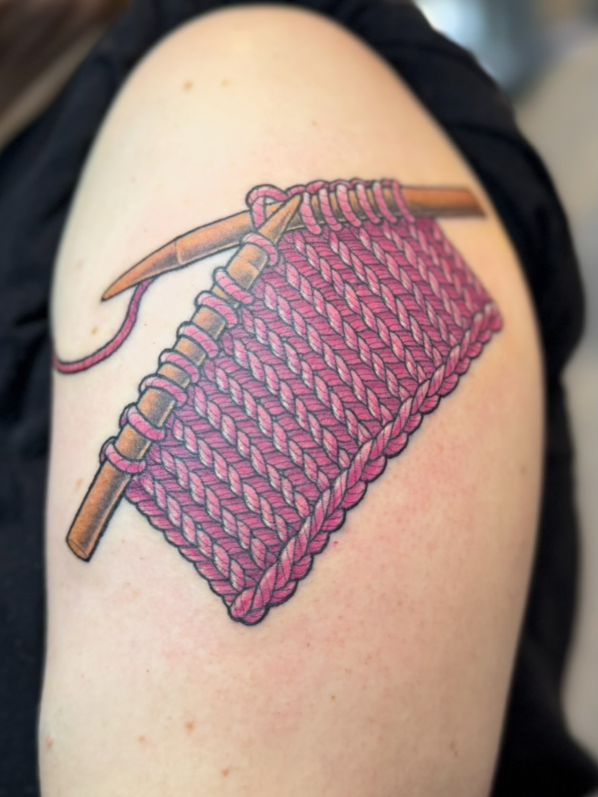 Knitting needles and yarn realism tattoo on the shoulder by Erin Bratzler