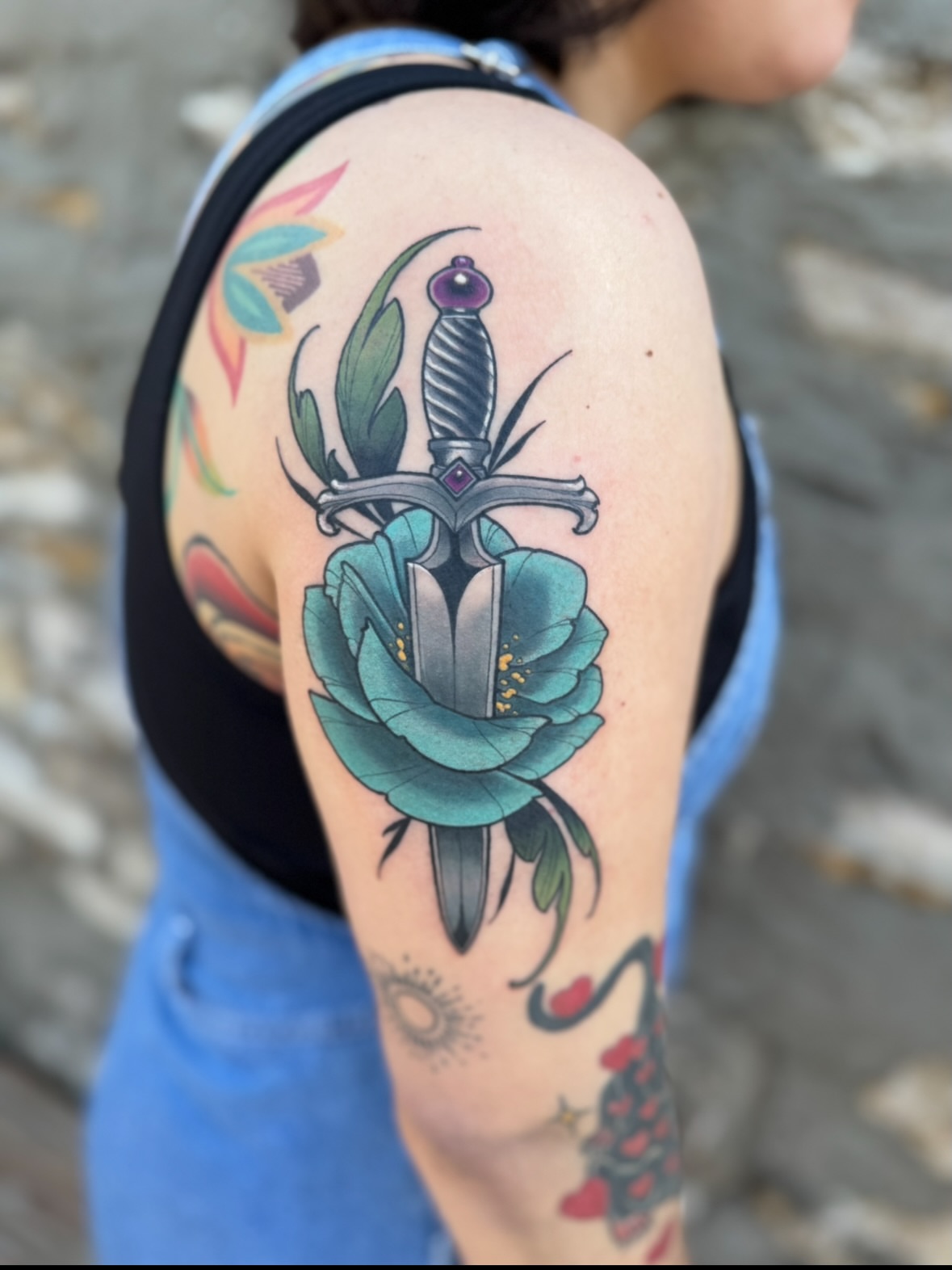 Sword and rose American traditional tattoo on the shoulder by Erin Bratzler