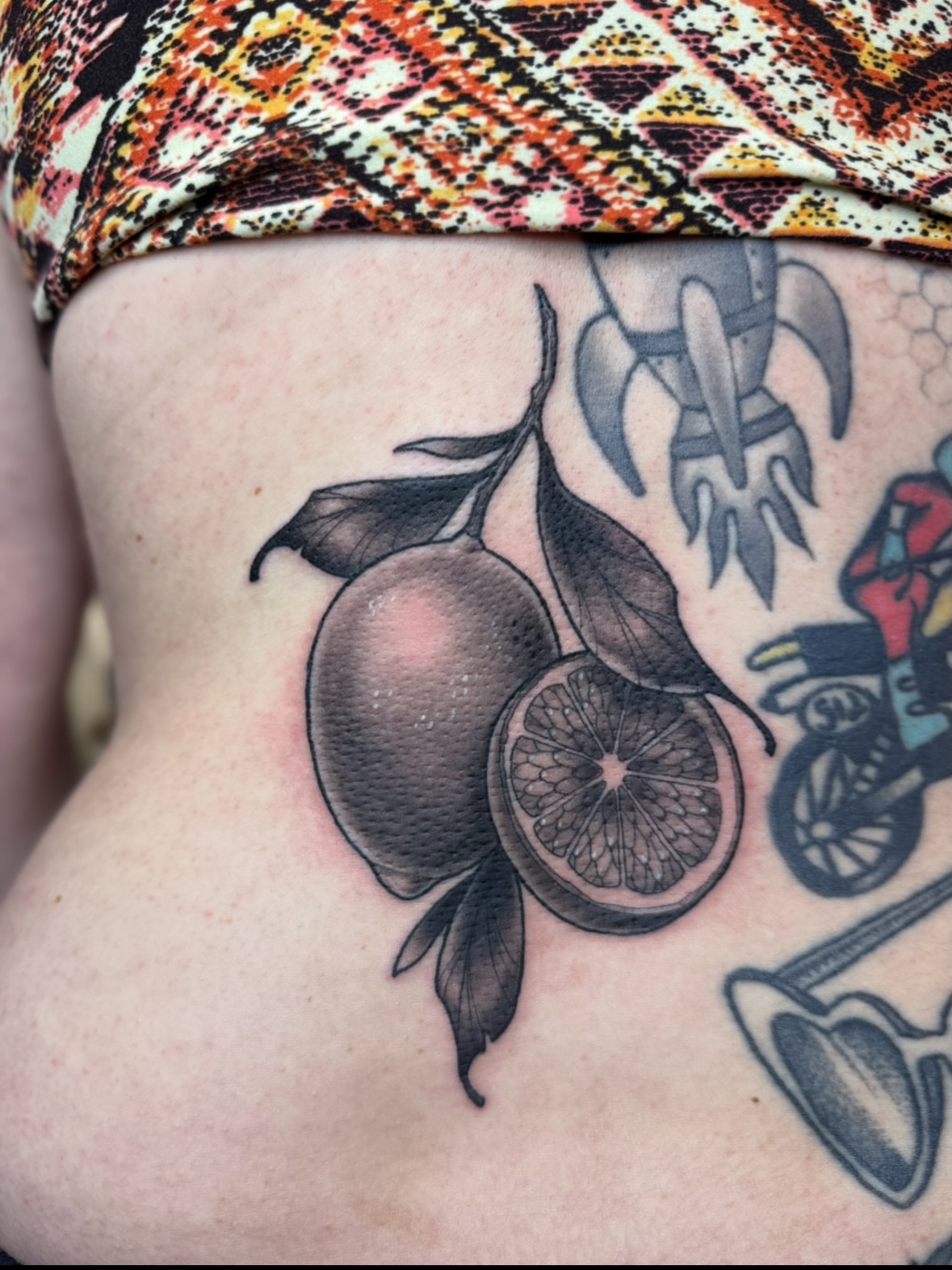 Orange slice realism tattoo on the thigh by Erin Bratzler