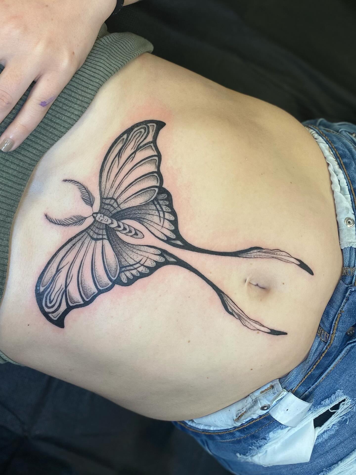 Bird black and grey tattoo on the ribs by Casey Dohner