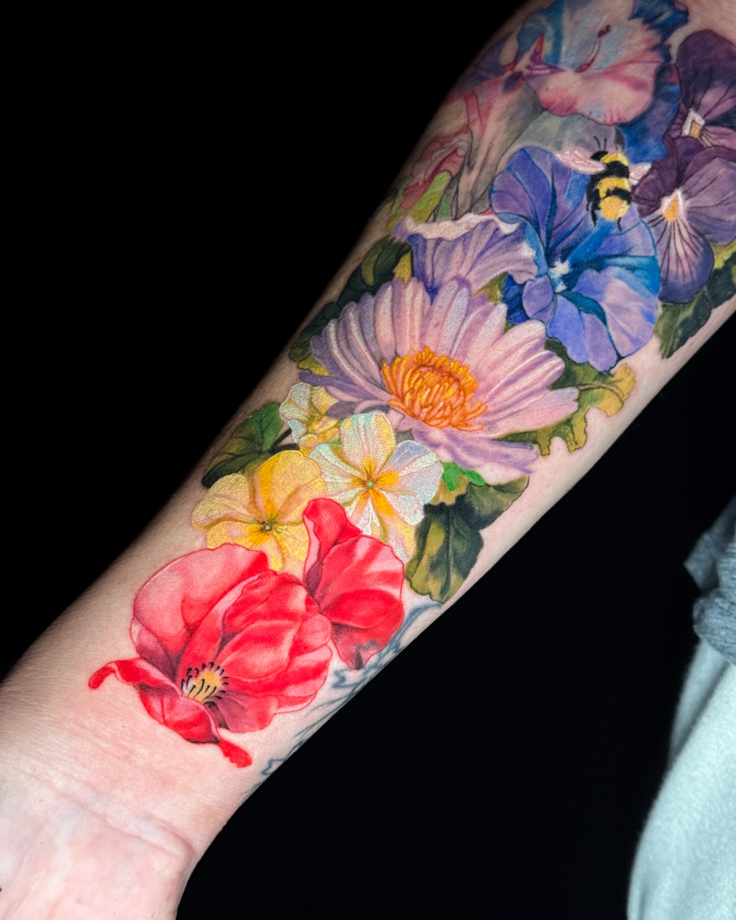 Floral bouquet watercolor tattoo on the forearm by Luiny