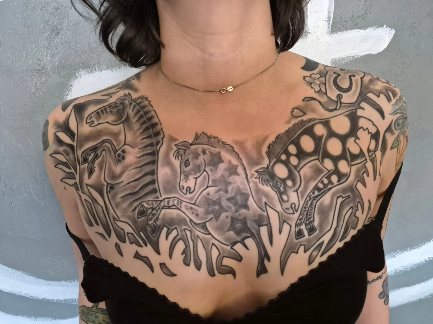 Dinosaur and stars black and grey tattoo on the chest by Matt Williamson