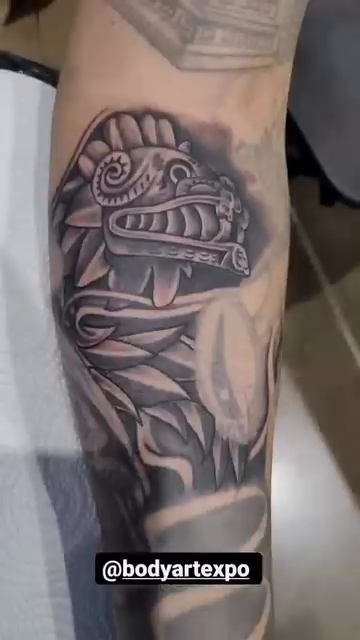 Aztec serpent head realism tattoo by professional tattoo artist