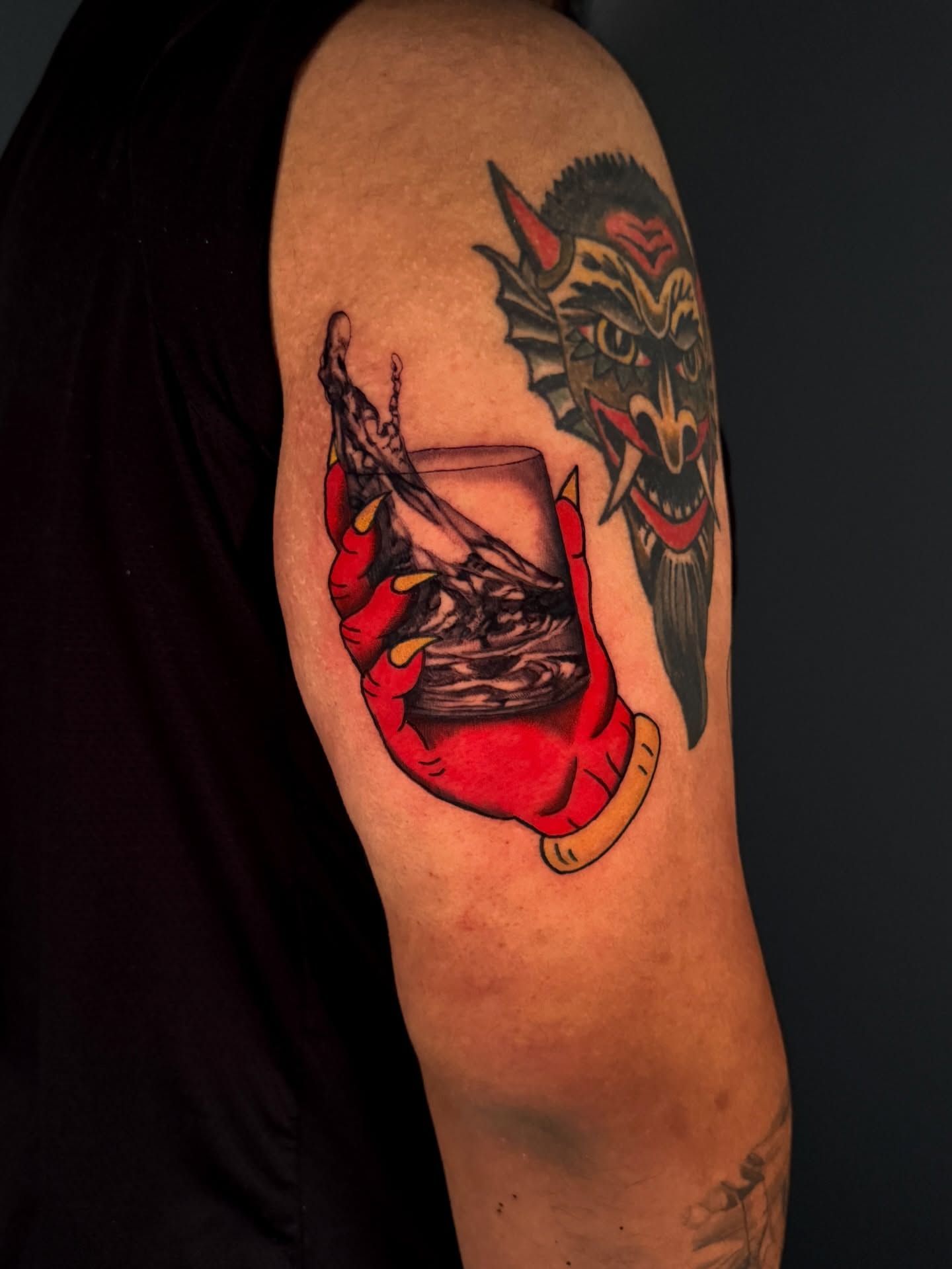 Demon and glass American traditional tattoo on the upper arm by Dallas Tattoo Artist