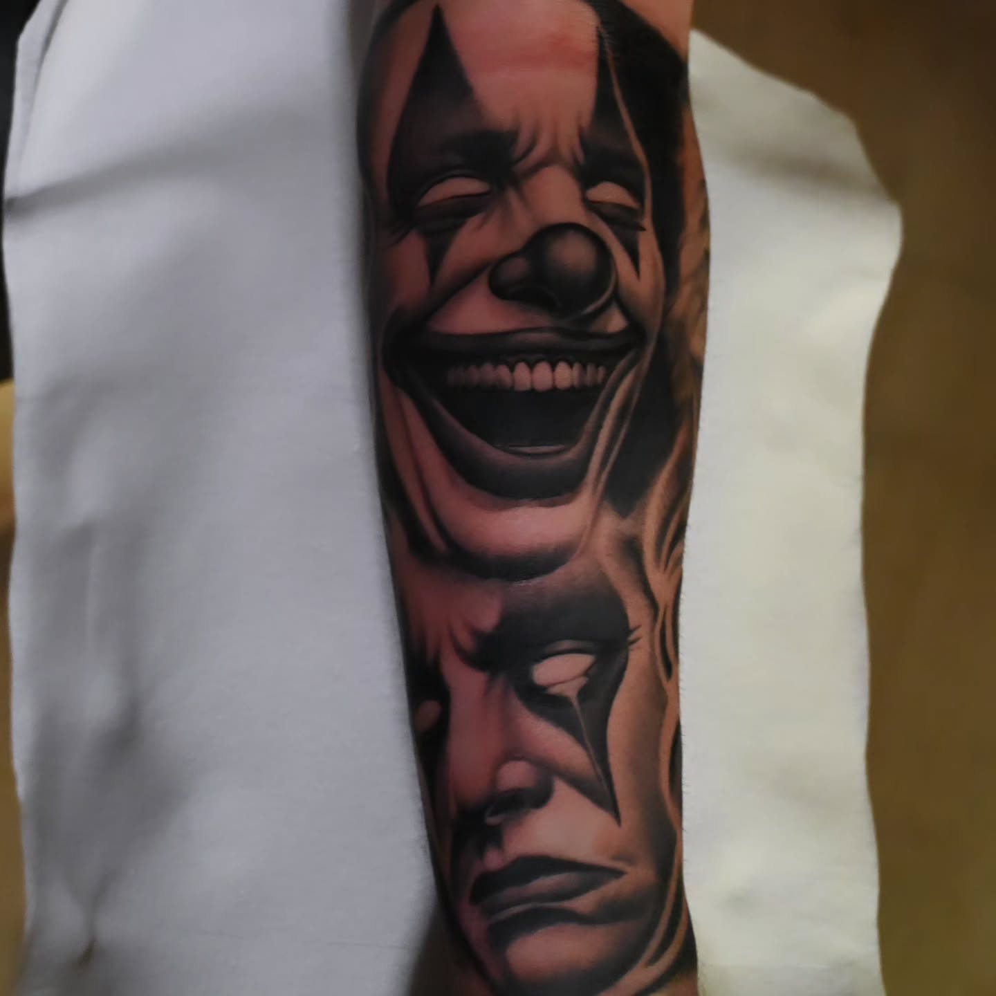 Clown realism tattoo on the forearm by Michael ORegan