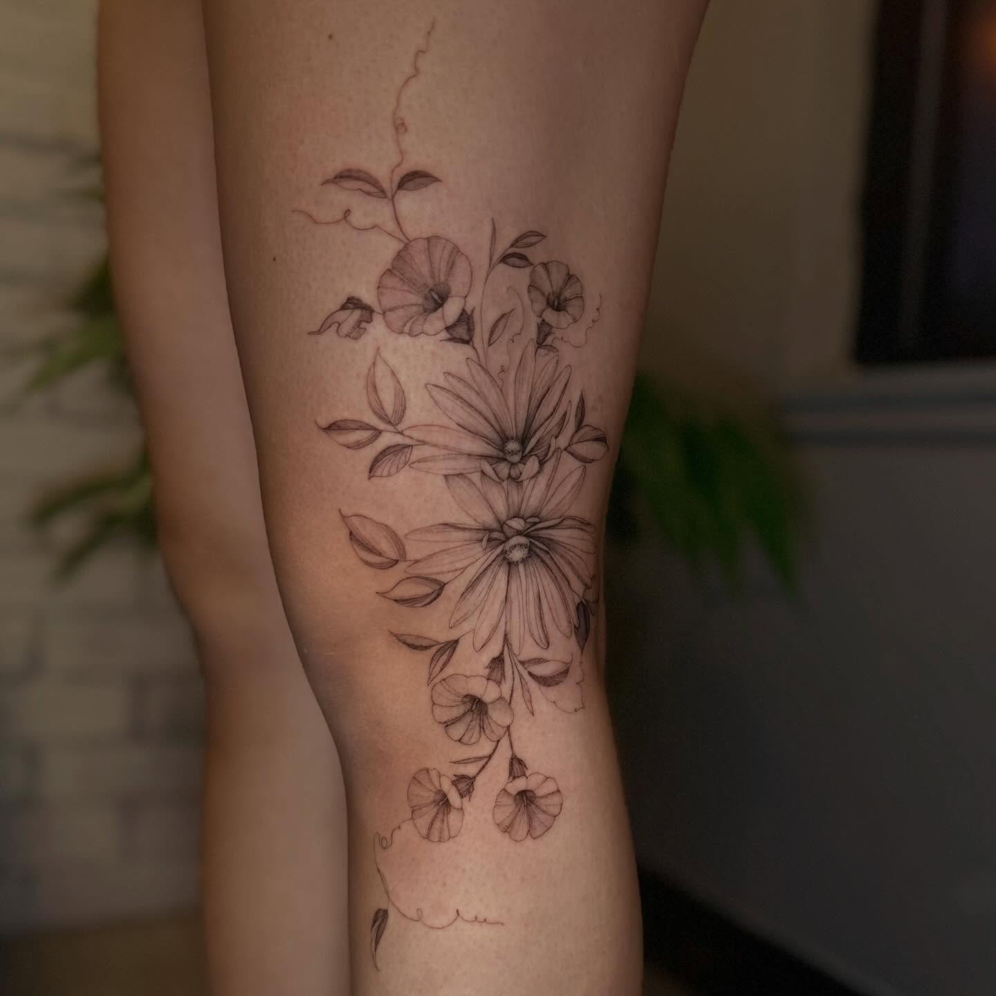 Floral arrangement black and grey tattoo on the calf by ❀ Moo, Mount Laurel, New Jersey