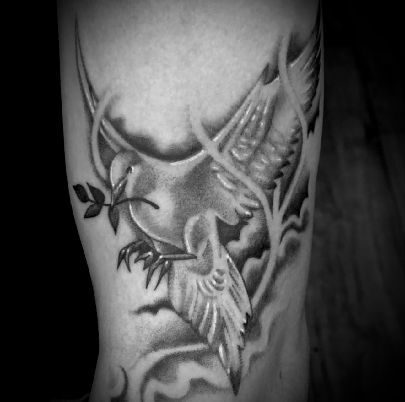 Bird and tree black and grey tattoo on the forearm by Big Steve Lewis