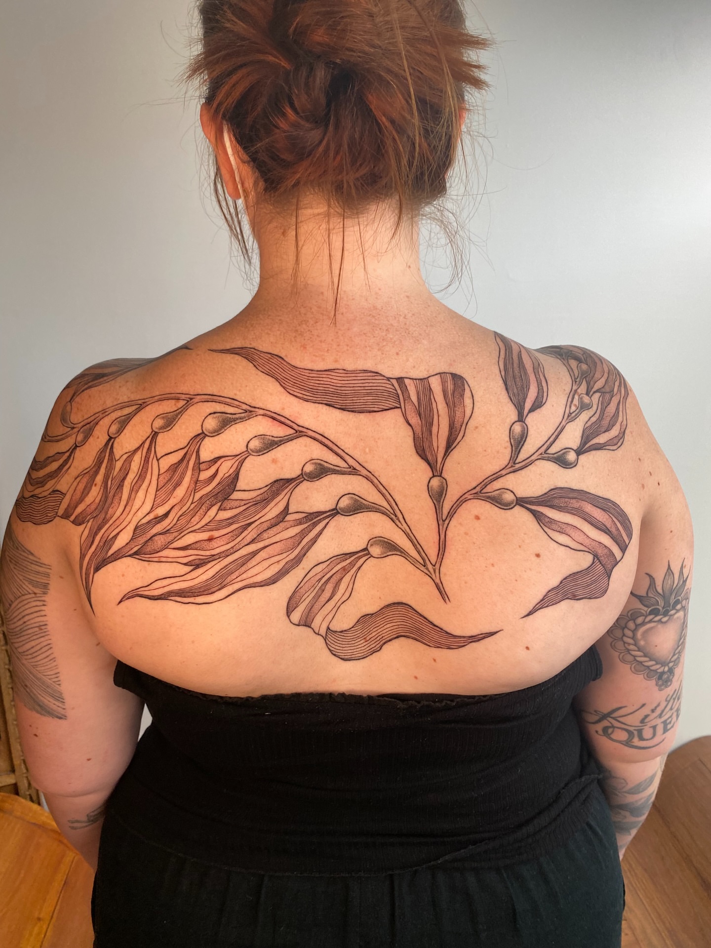 Plant black and grey tattoo on the back by Avery Kane