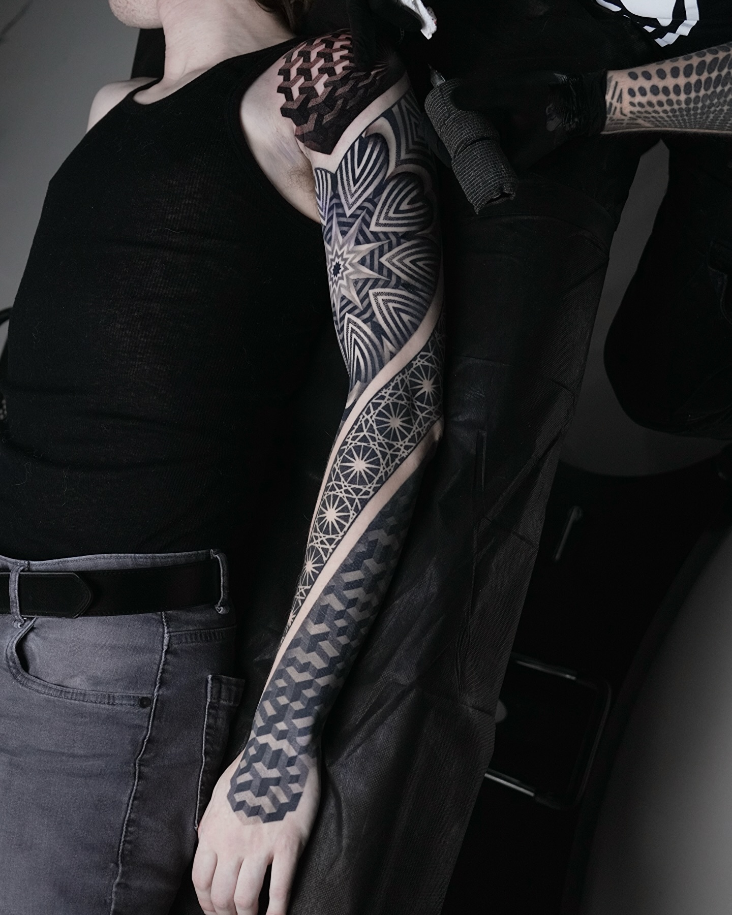 Geometric patterns and optical illusions geometric tattoo on the upper arm by Ilya Cascad Kandaurov