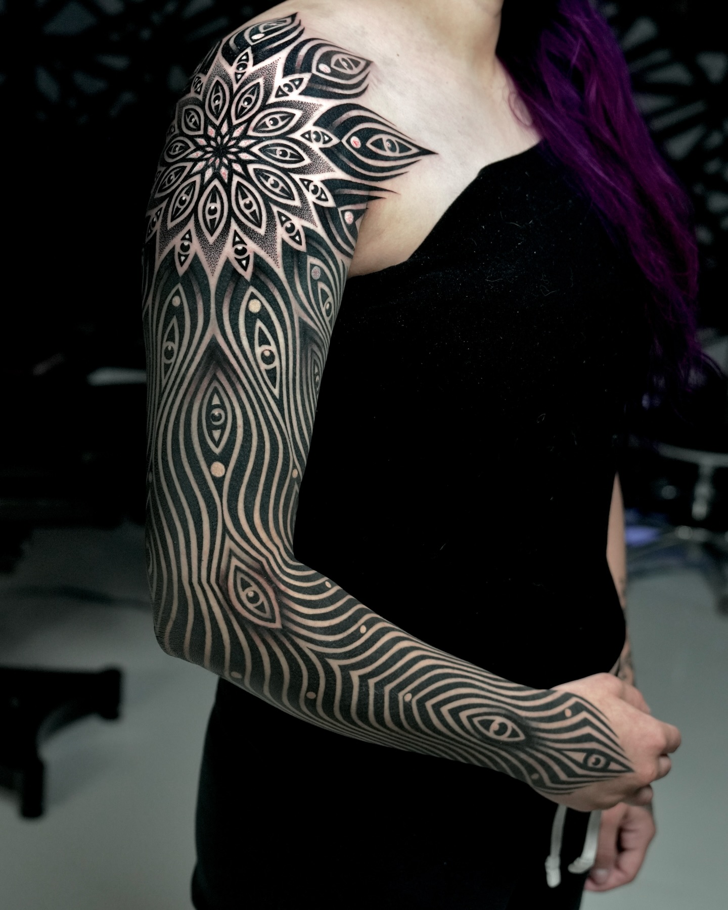 Geometric mandala with eyes geometric tattoo on the upper arm by Ilya Cascad Kandaurov