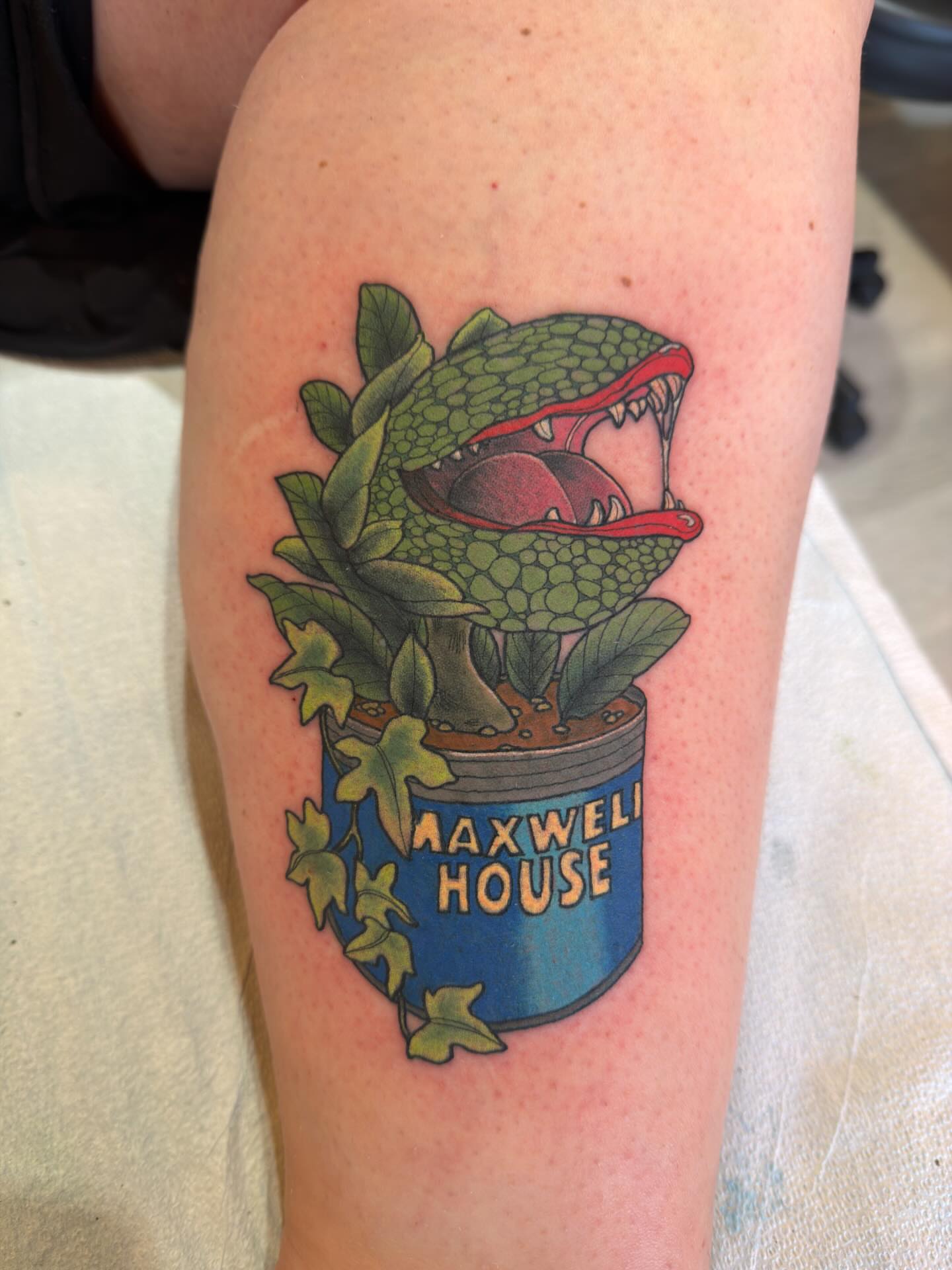 Ivy-covered lizard neo-traditional tattoo on the forearm by Patrick Carroll