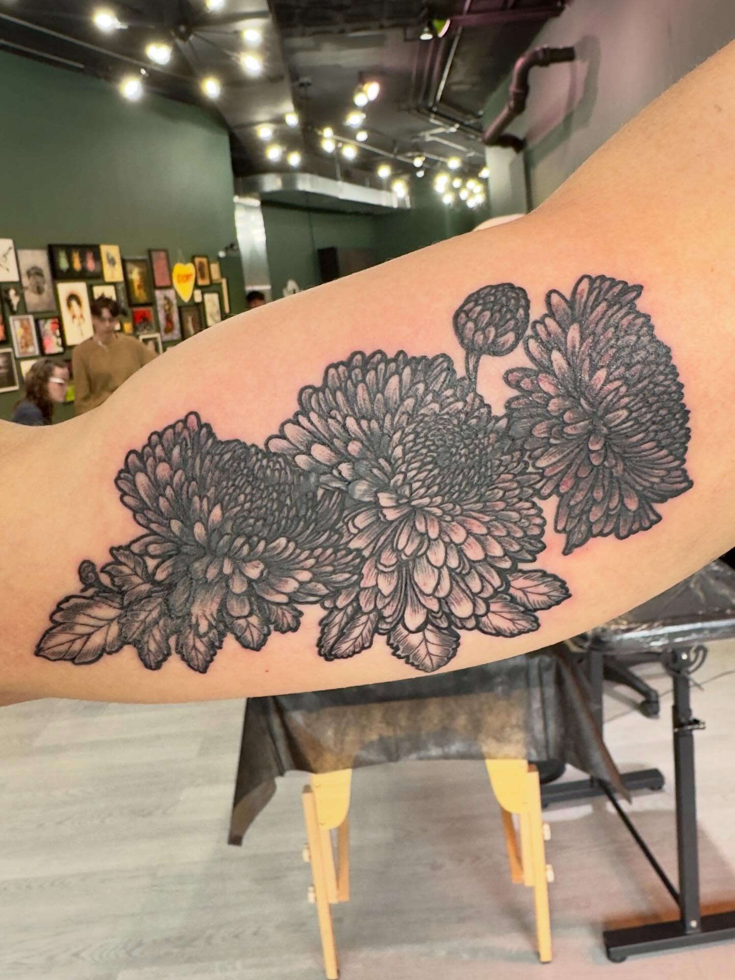 Chrysanthemums black and grey tattoo on the forearm by Patrick Carroll