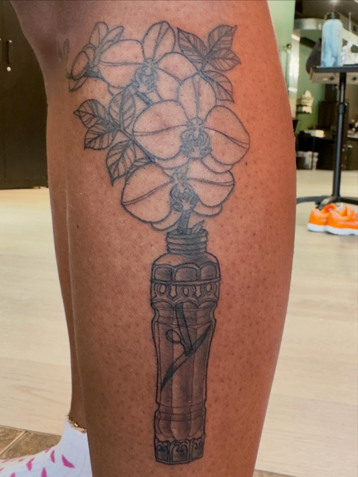 Flower bouquet black and grey tattoo on the leg by Patrick Carroll