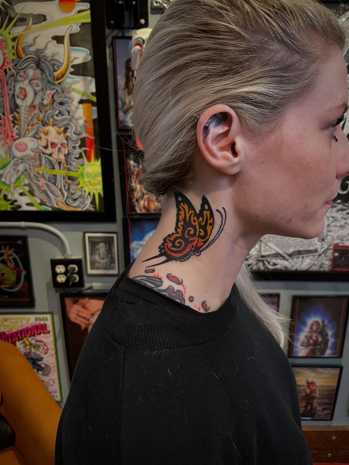 Butterfly neo-traditional tattoo on the neck by Zac Blevins