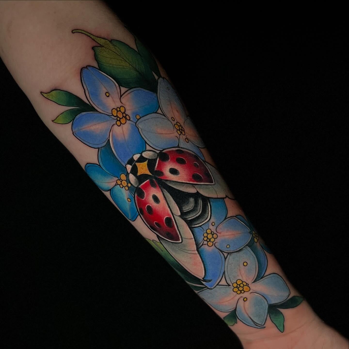 Flowers and ladybugs American traditional tattoo on the forearm by 🕯Heather🕯