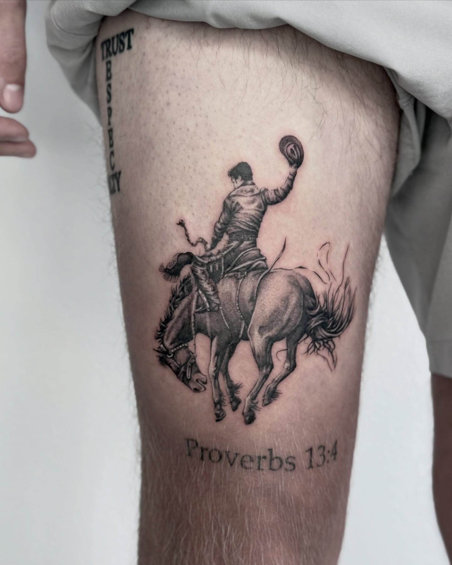 Cowboy on horse black and grey tattoo on the thigh by Miro Ink Tattoo