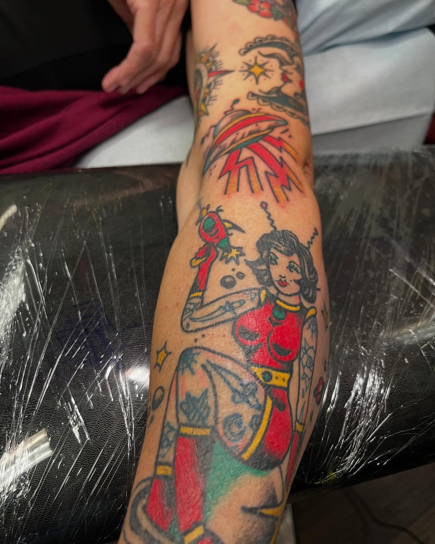 Female pin-up character American traditional tattoo on the forearm by monk