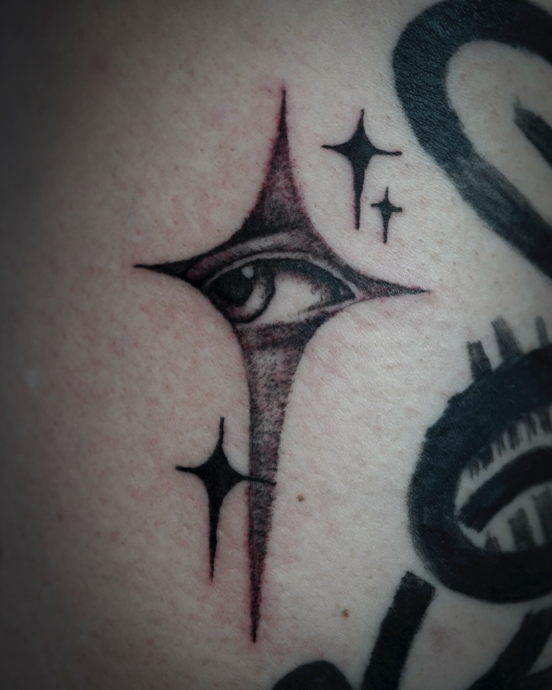 Eye with stars black and grey tattoo on the forearm by Spicoli