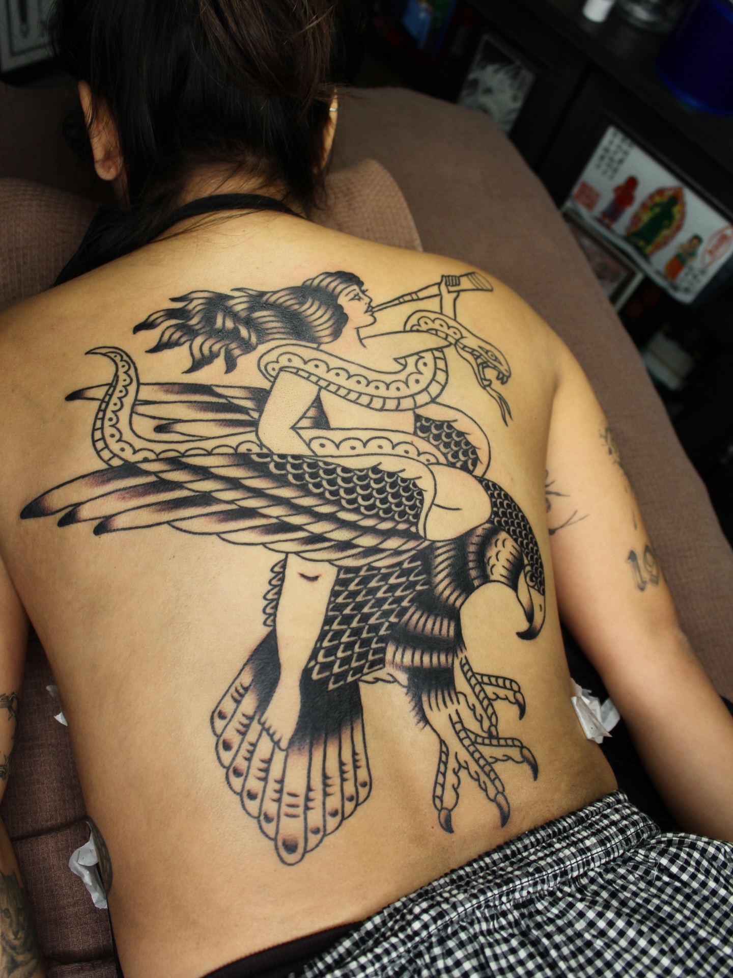 Mermaid with snake American traditional tattoo on the back by Kehrmie Tattoos, Berkeley, California