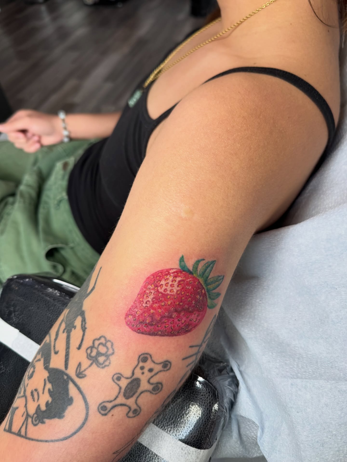 Strawberry realism tattoo on the forearm by Nathalie Briseno