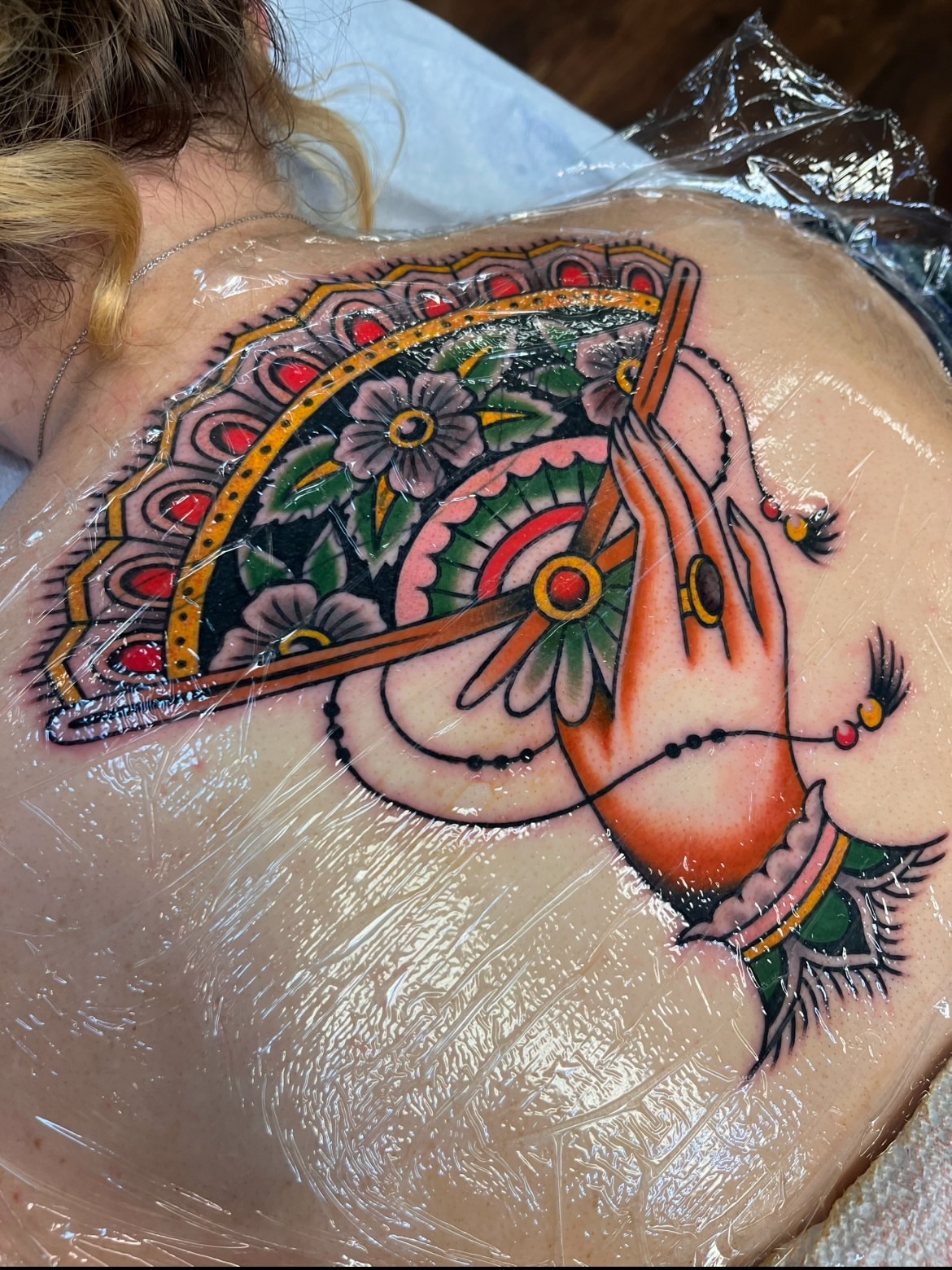 Praying hands American traditional tattoo on the back by Macy Bird