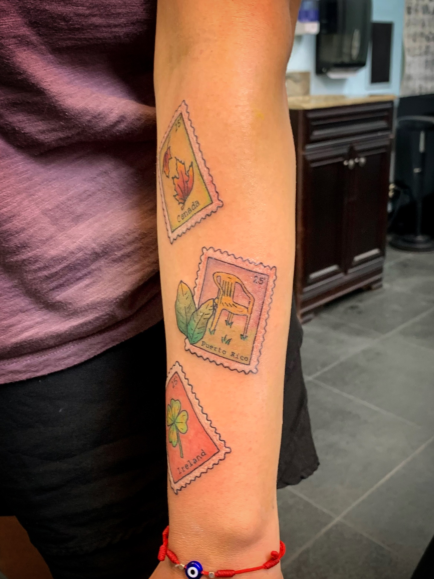 Postage stamps dotwork tattoo on the forearm by Laura