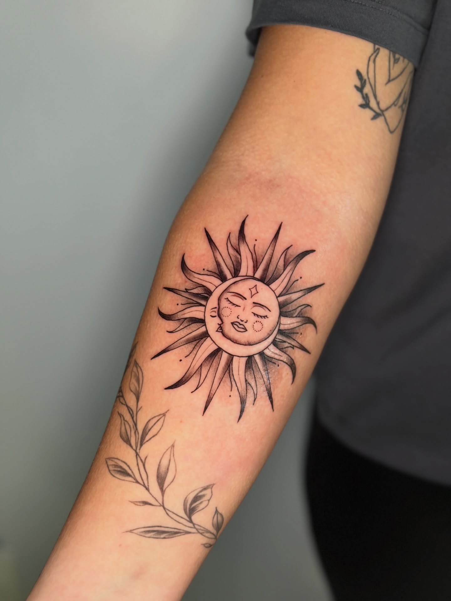 Sun black and grey tattoo on the forearm by Mandy Kaur