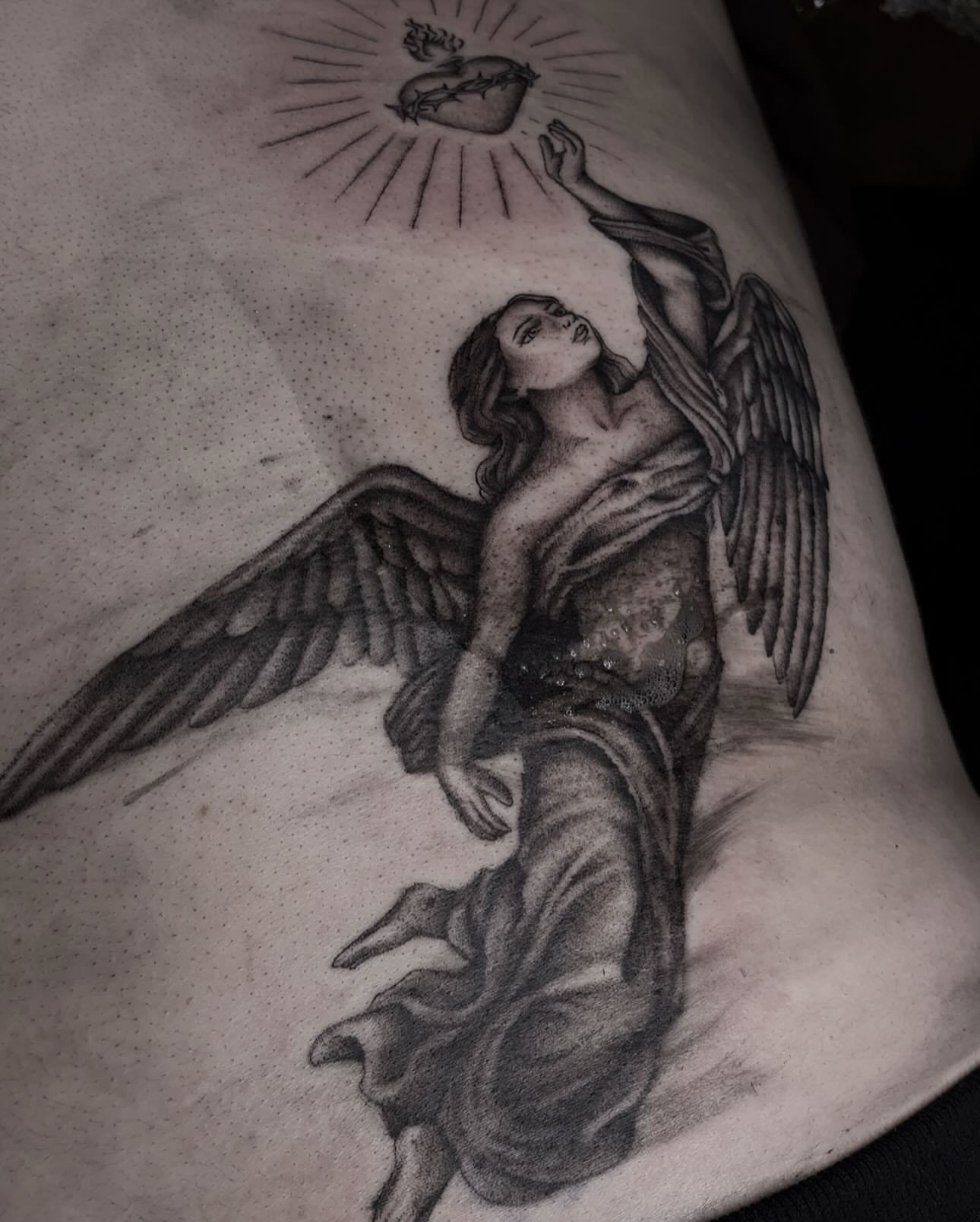 Angel with heart realism tattoo on the thigh by l i z ✶