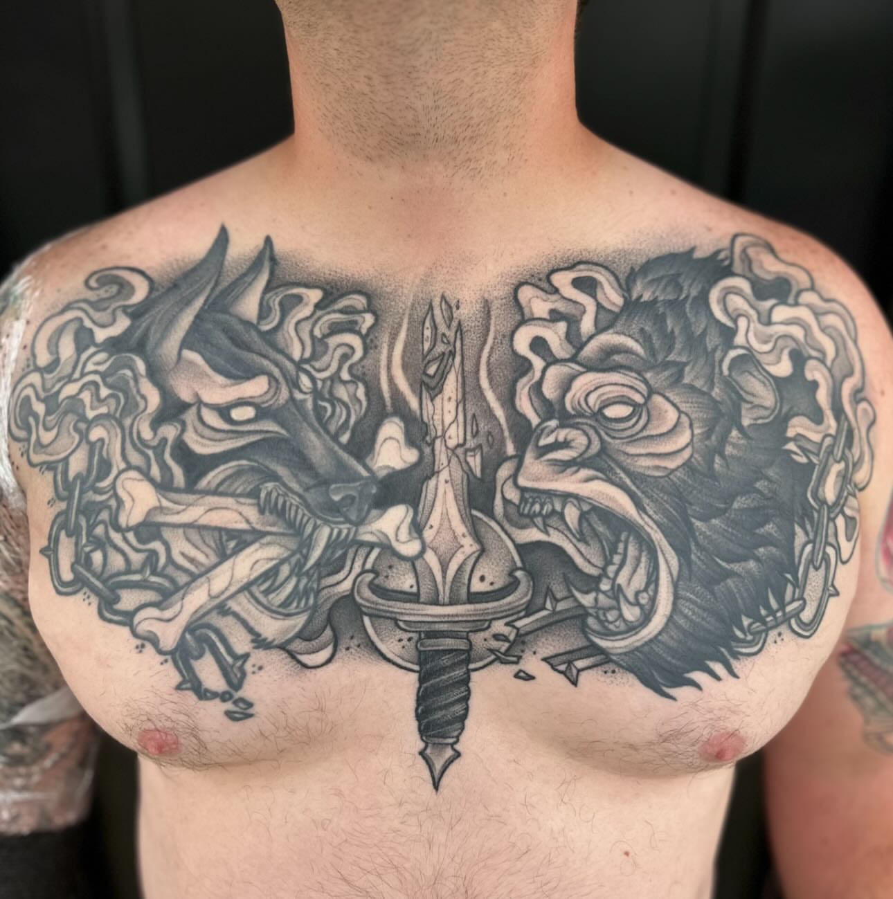 Sword and dragons realism tattoo on the chest by Madison Orchard Tattoos