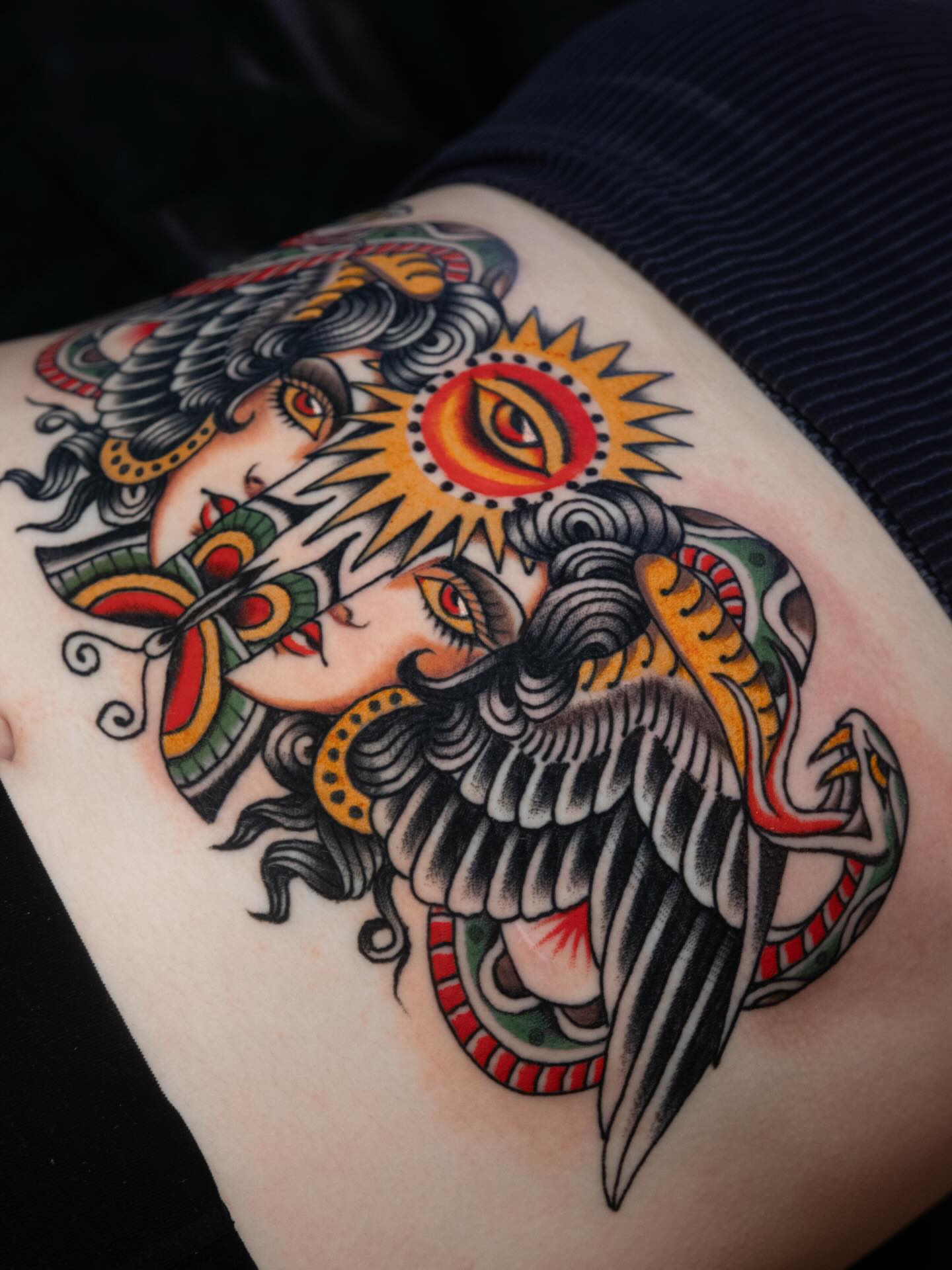 Woman with sun American traditional tattoo on the thigh by Danny Derrick, San Luis Obispo, California