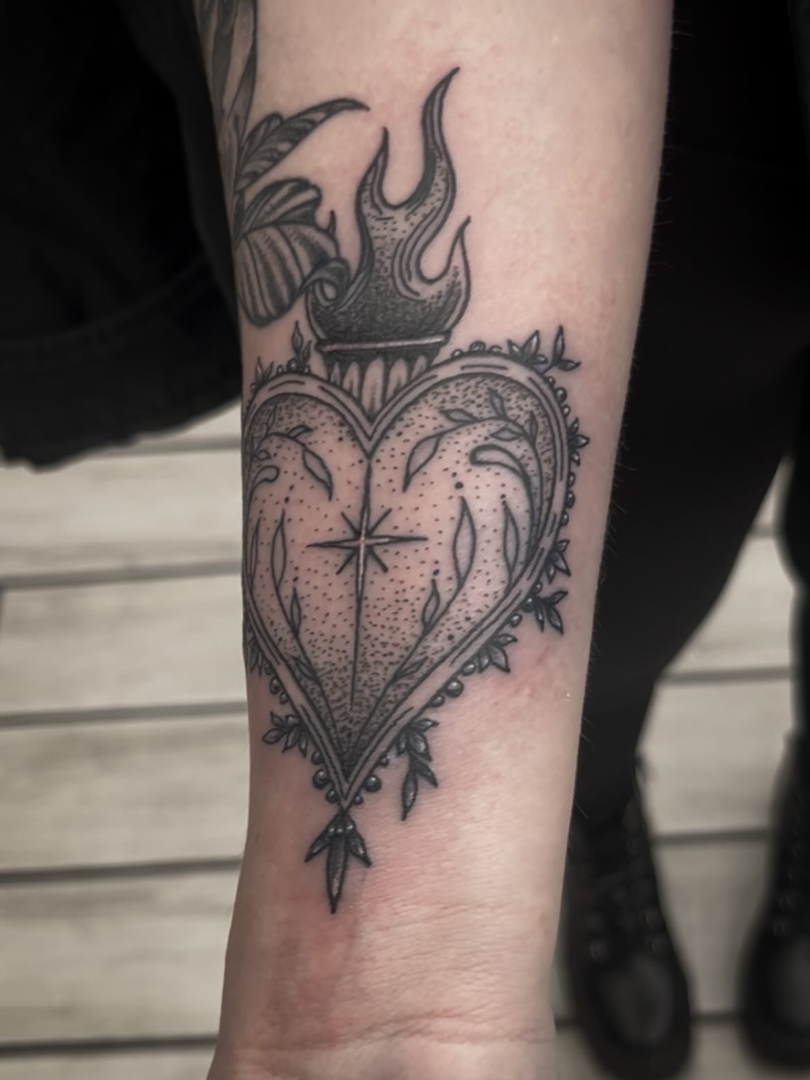 Heart with flame black and grey tattoo on the forearm by Sean Gallagher