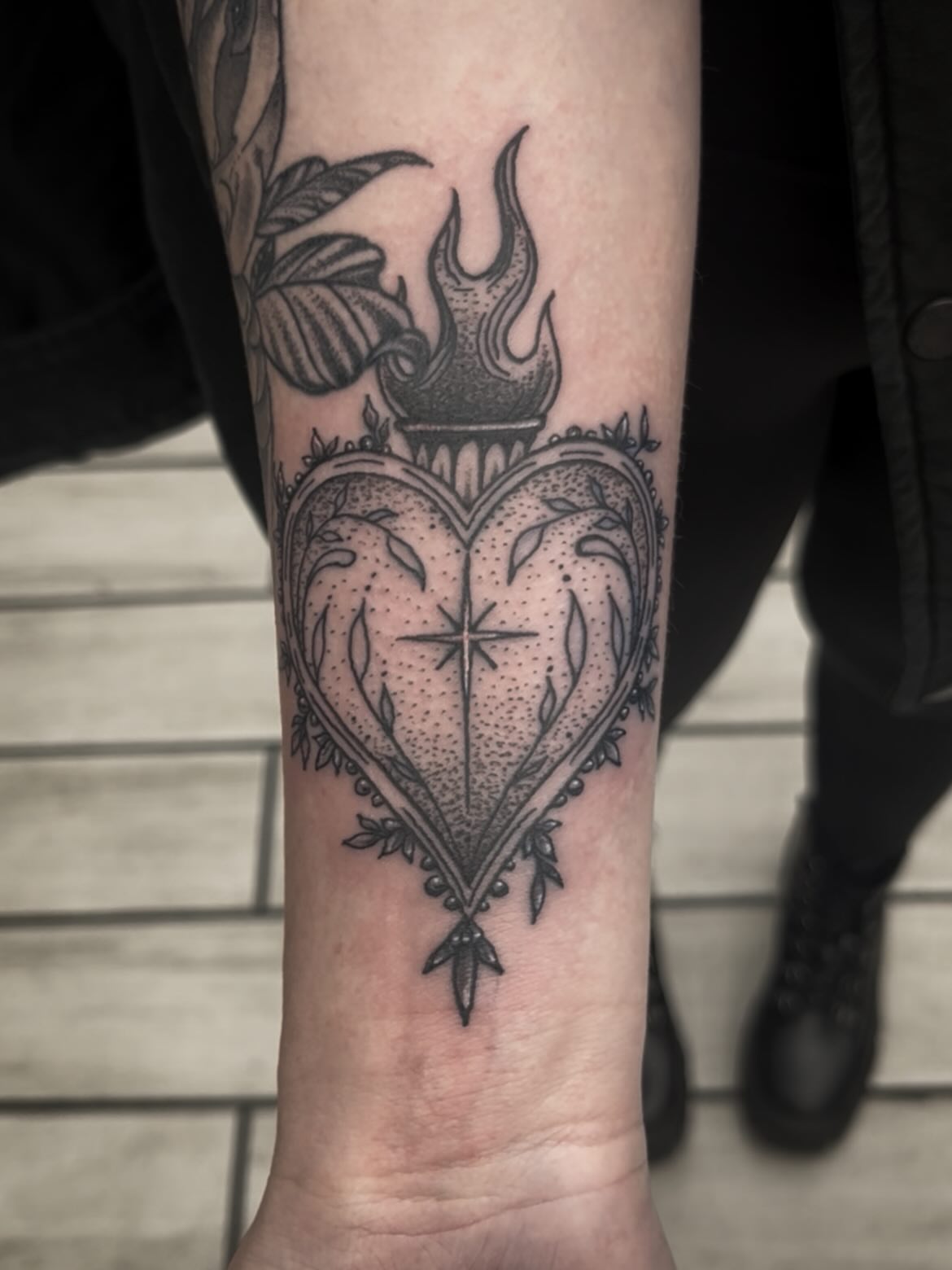Heart with flame dotwork tattoo on the forearm by Sean Gallagher