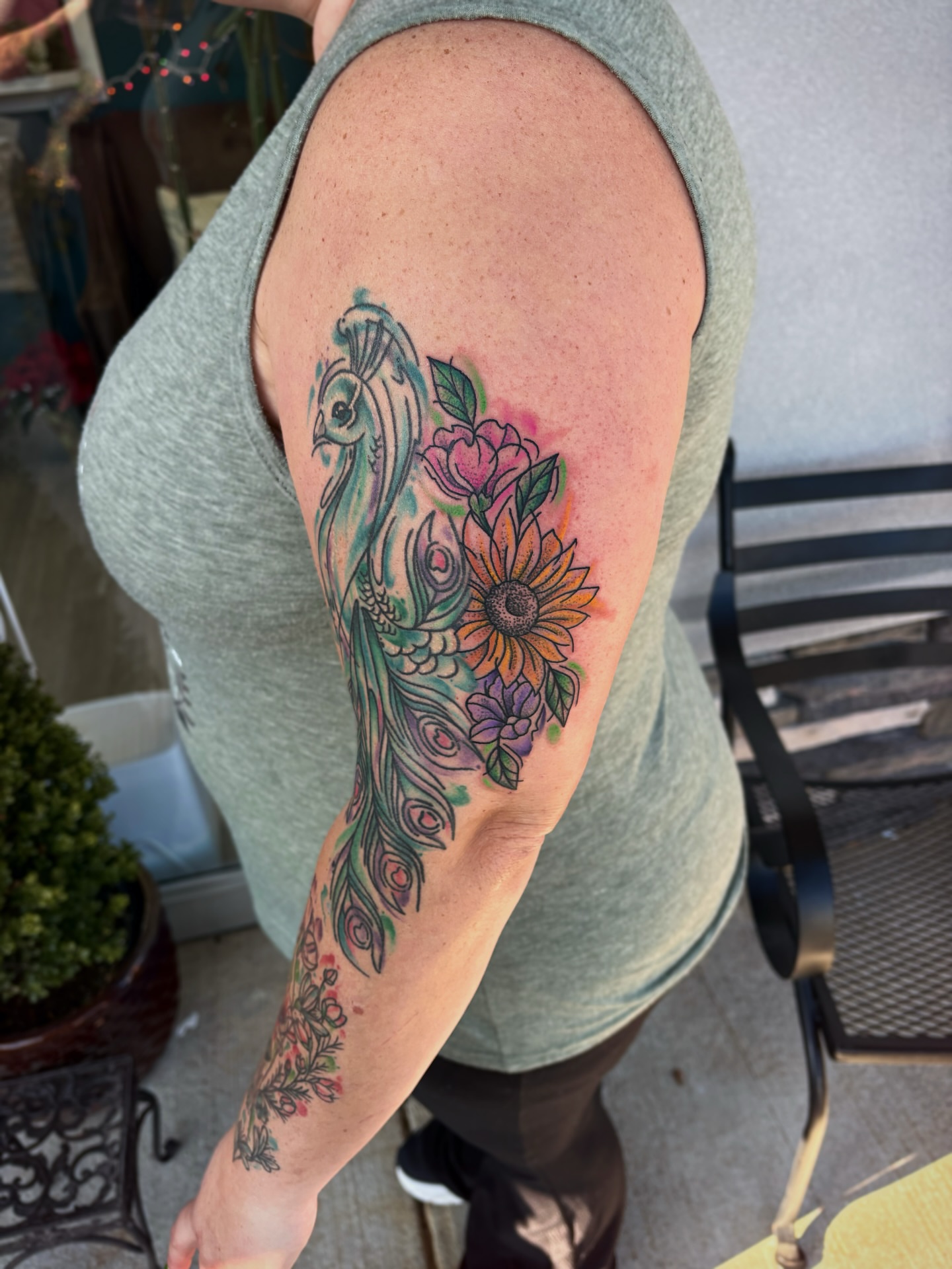 Peacock and flowers new school tattoo on the forearm by Bunny Noel