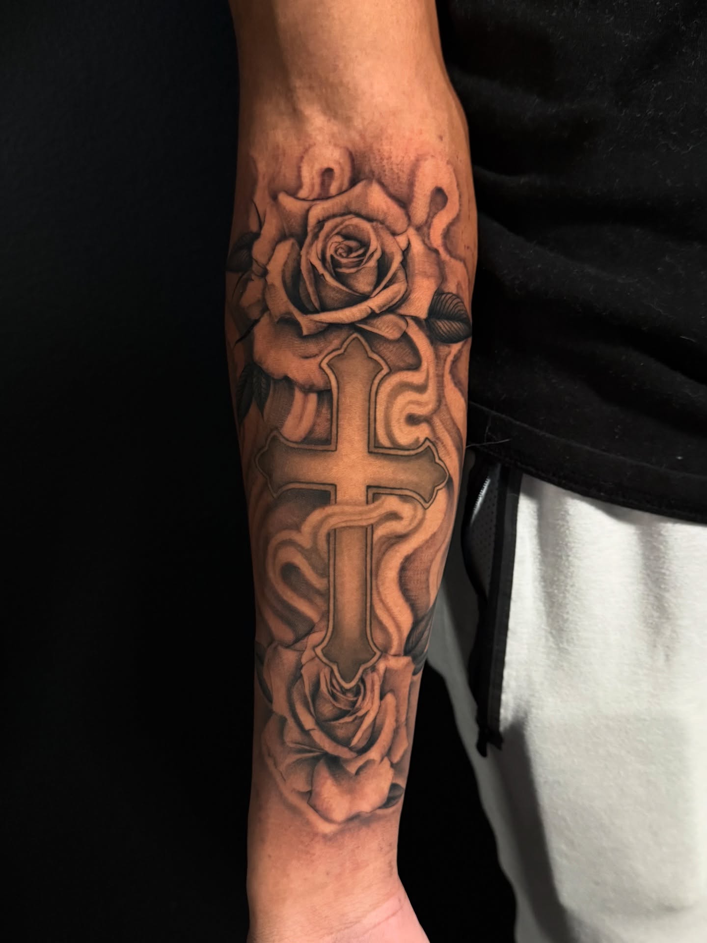 Cross and roses realism tattoo on the forearm by HAiZiE