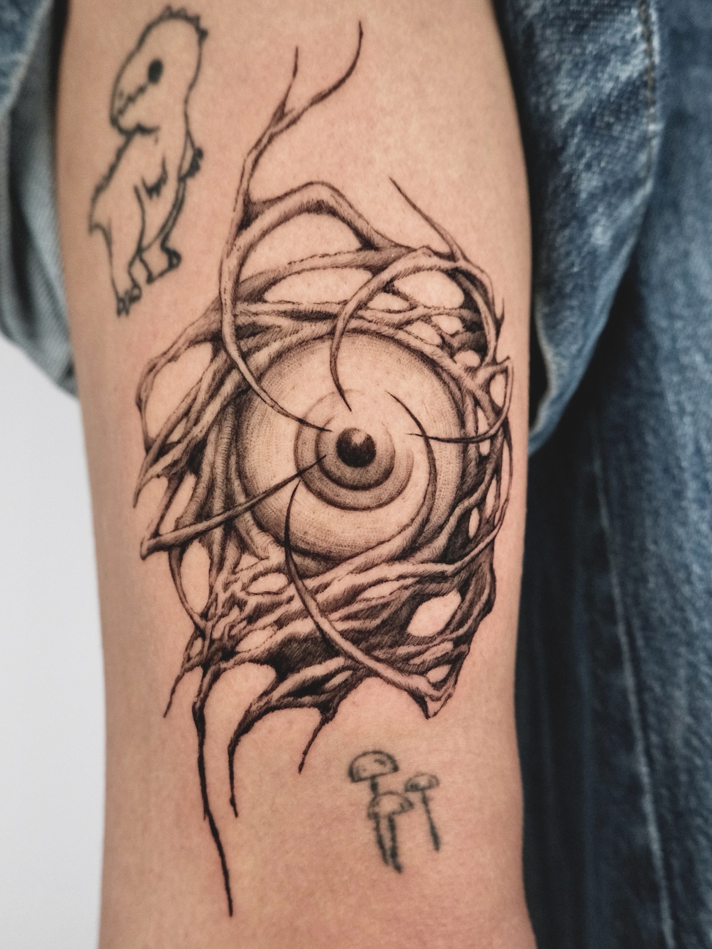 Eye with tendrils surrealism tattoo on the forearm by HanaKaki