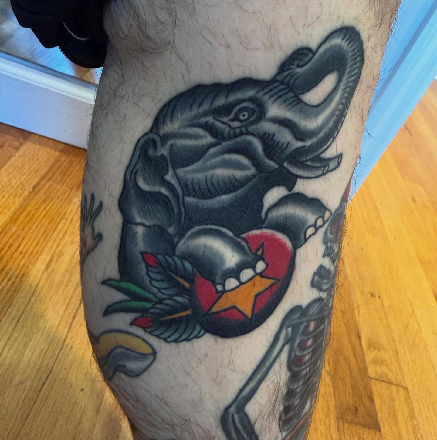 Elephant and heart American traditional tattoo on the thigh by Mike Kepper