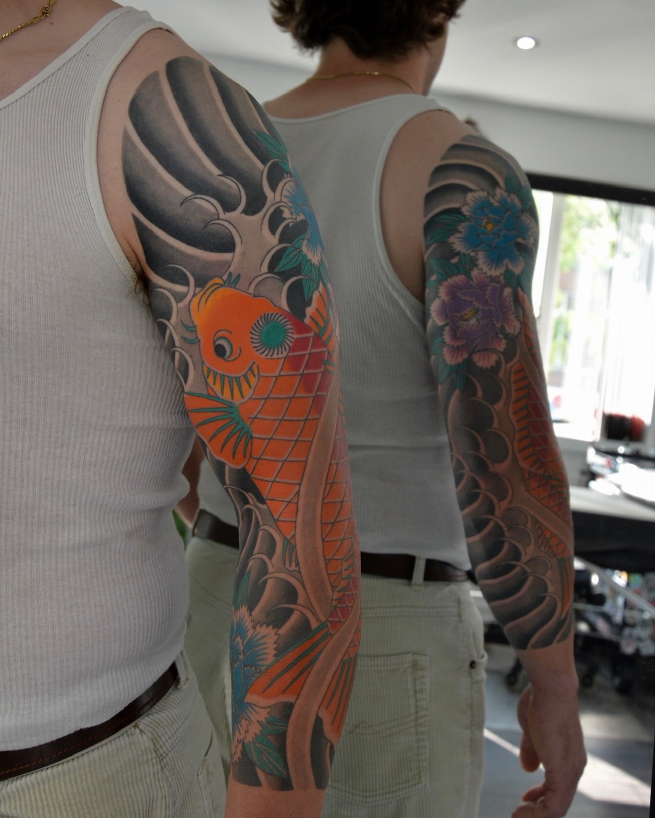 Koi fish and floral japanese irezumi tattoo on the upper arm by zak brochu, Windsor, Ontario
